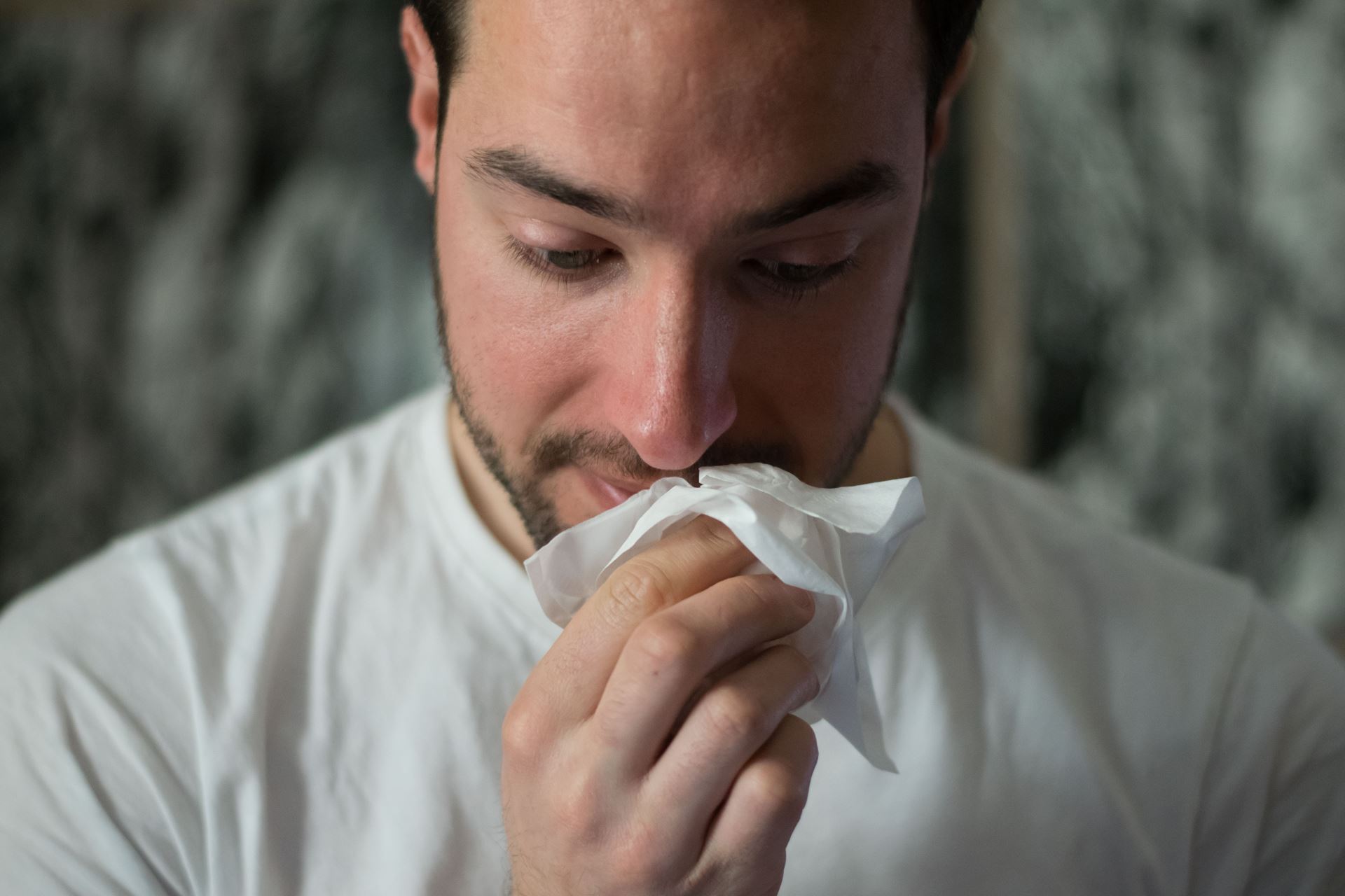 a man blowing his nose